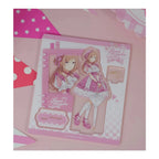 Acrylic stand parts on the printed sheet: Rinami Himesaki figure in a pink lolita dress, base and signature plate
