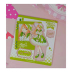 Acrylic stand parts on the printed sheet: Sumika Shiun figure in a green lolita dress, base and signature plate