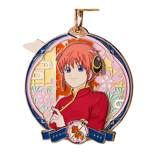 Kagura medal with cherry blossoms, a pink inner ring, a blue ribbon and a gold ribbon and ring on top