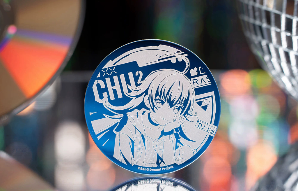 The CHU² badge standing in front of a CD and a mirror ball (props not included)