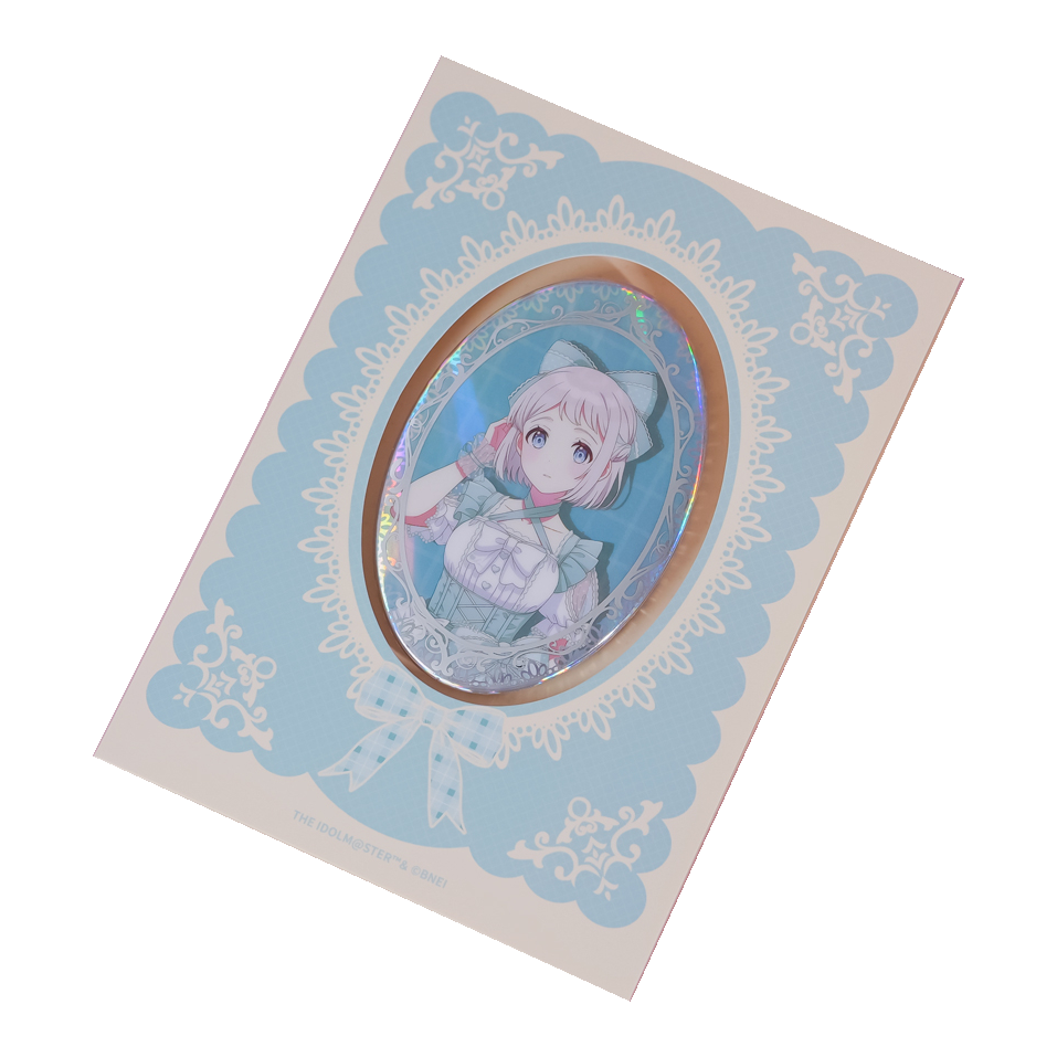 Lilja Katsuragi oval holographic badge on its pale blue lace-patterned backing card.