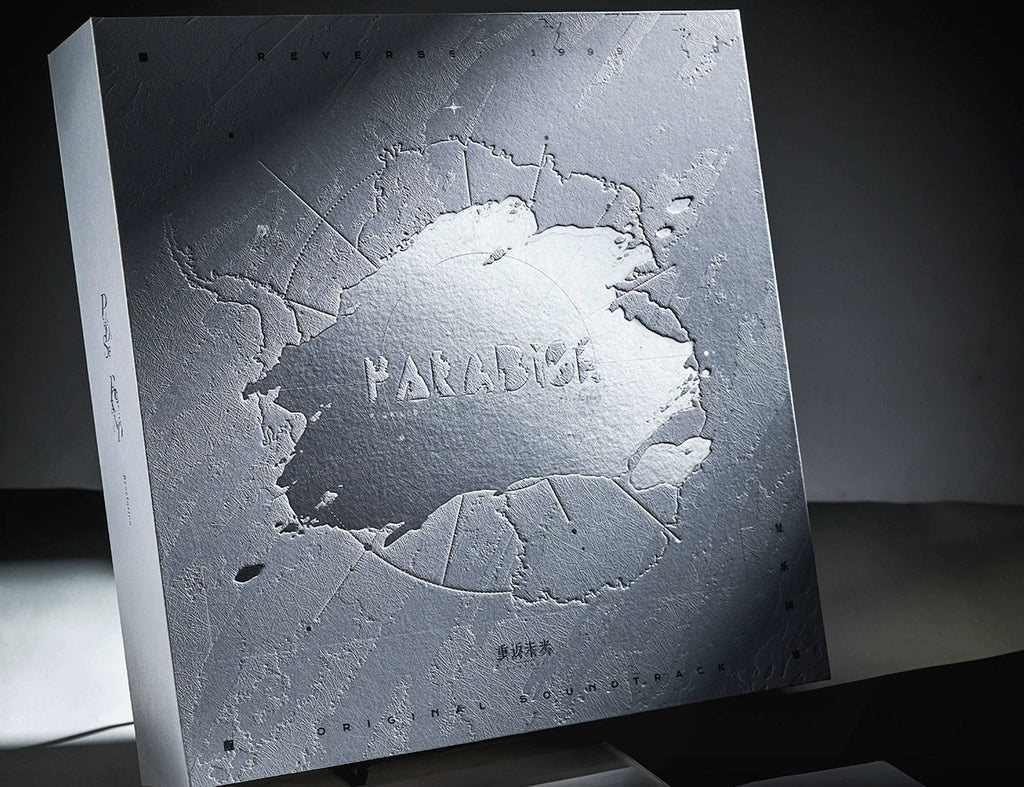 Front of the gift box: embossed snowfield texture with silver-foil PARADISE lettering