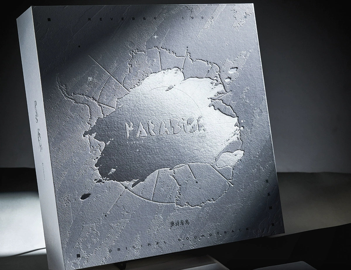 Front of the gift box: embossed snowfield texture with silver-foil PARADISE lettering