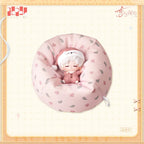 Sleeping Sylus figure in pajamas and a nightcap, seated in a matching patterned miniature beanbag.