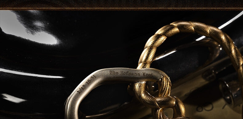 Close-up of the ring engraved 'The Hofmann Knot' with a date and time