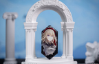Doloris (Uika Misumi) badge standing in a white arch display prop