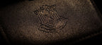 Close-up of the debossed crest on the card holder cover