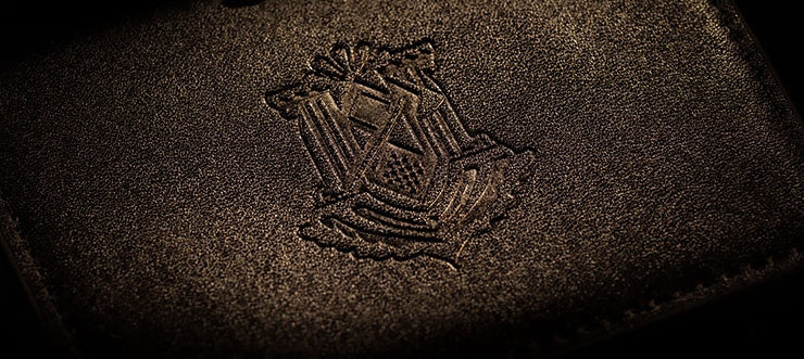 Close-up of the debossed crest on the card holder cover