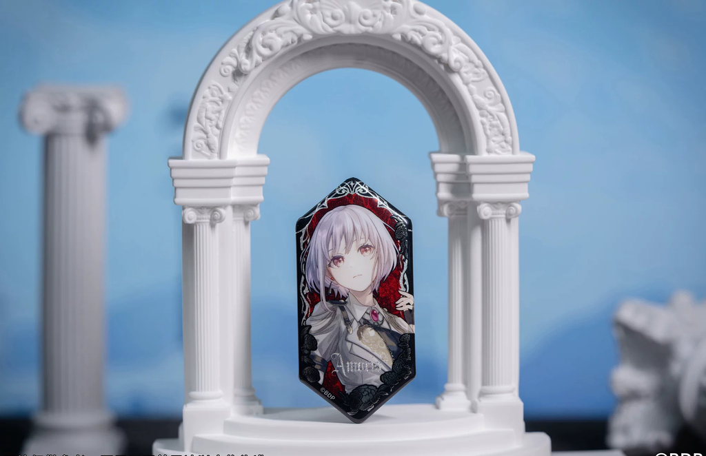 Amoris (Nyamu Yutenji) badge standing in a white arch display prop