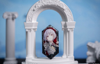 Amoris (Nyamu Yutenji) badge standing in a white arch display prop