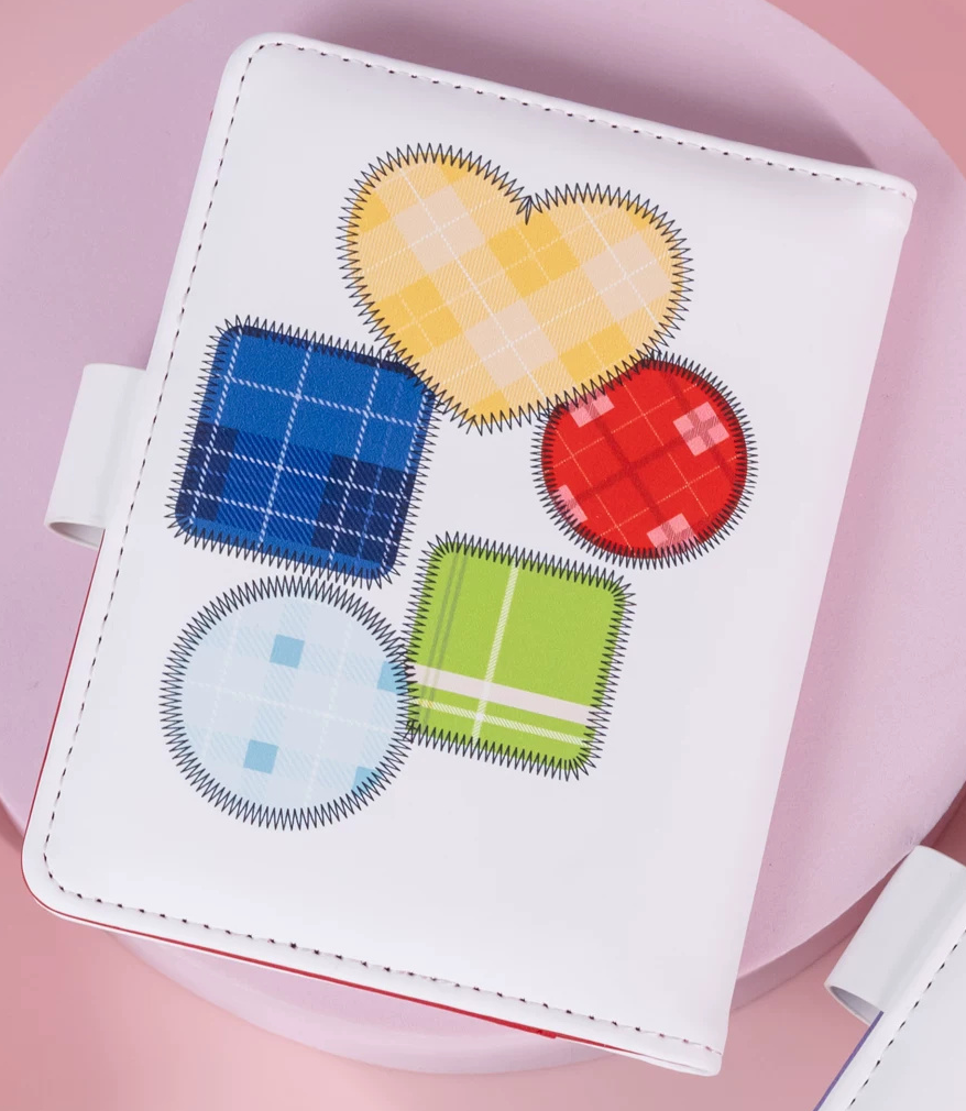 White cover of the Class 1-1 passport case with yellow, blue, red, light-blue and green plaid patches