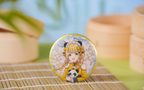 Kotone Fujita design: gold-rimmed badge with Kotone holding a panda plush