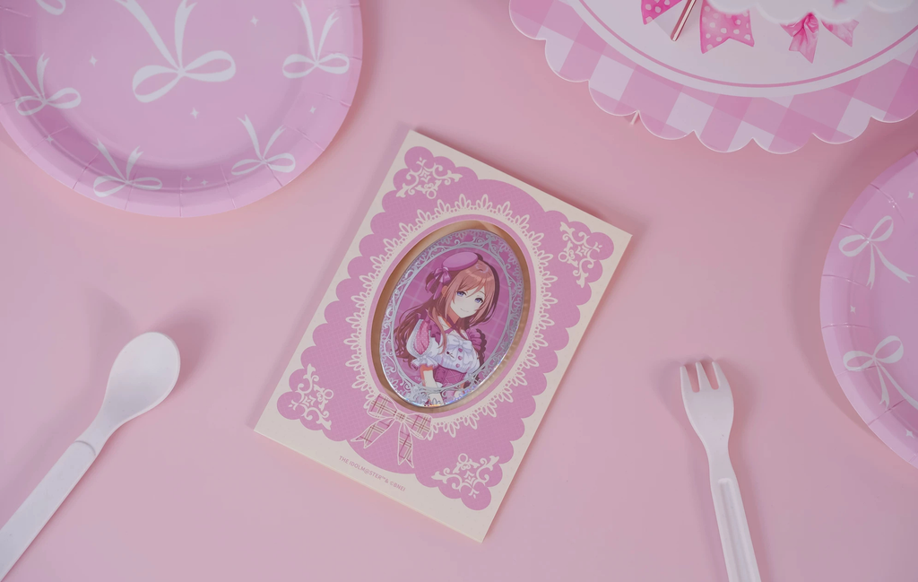 Rinami Himesaki badge in its pink lace-patterned backing card on a pink table with tableware (props not included)