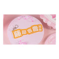 Name keychain: orange-yellow plate reading "藤田言音担当" in white, with a clasp and a small clear charm