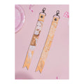 Orange ribbon keychain, front and back: Sena Juo in a brown lolita dress; the back reads Sena Juo