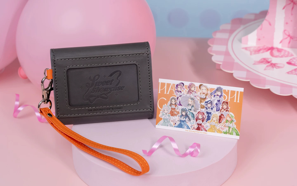 Back of the case with the pressed Sweet Showcase logo, beside the included card showing all 13 idols