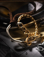 Another angle showing the leather cord looped through the ring and the gold knot