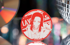 The LAYER badge standing in front of a CD and a mirror ball (props not included)