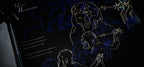 Lyric book inner page with gold and blue line art on black