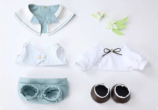 The outfit laid out separately: cape, vest, shirt, shorts, shoes, headpiece and corsage