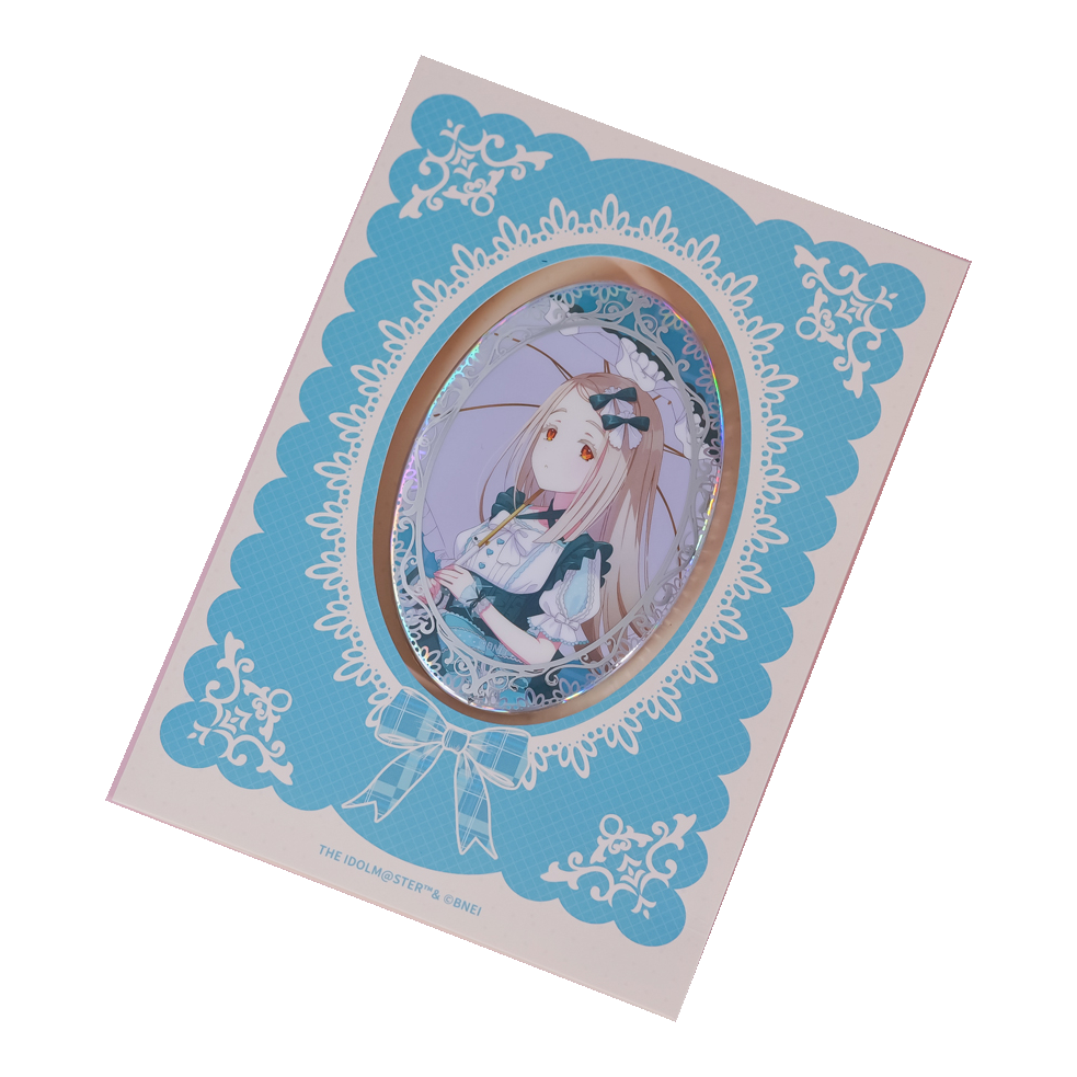 Hiro Shinosawa oval holographic badge on its turquoise lace-patterned backing card.