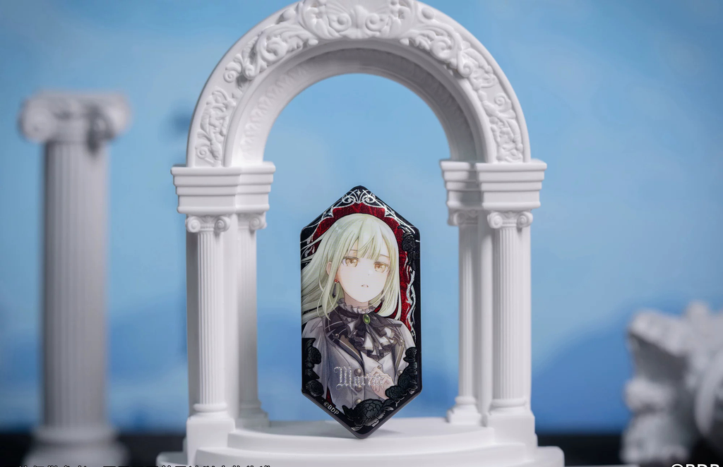 Mortis (Mutsumi Wakaba) badge standing in a white arch display prop
