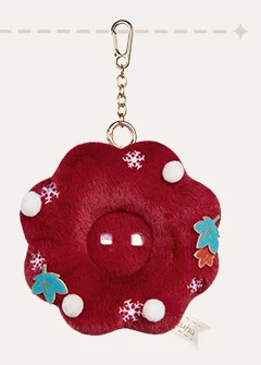 The deep-red flower-shaped backing on its own, with the metal clasp and chain