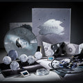 Gift box set with the marbled polar grey LP, embossed silver box, five badges, record mat, weight, films and booklet