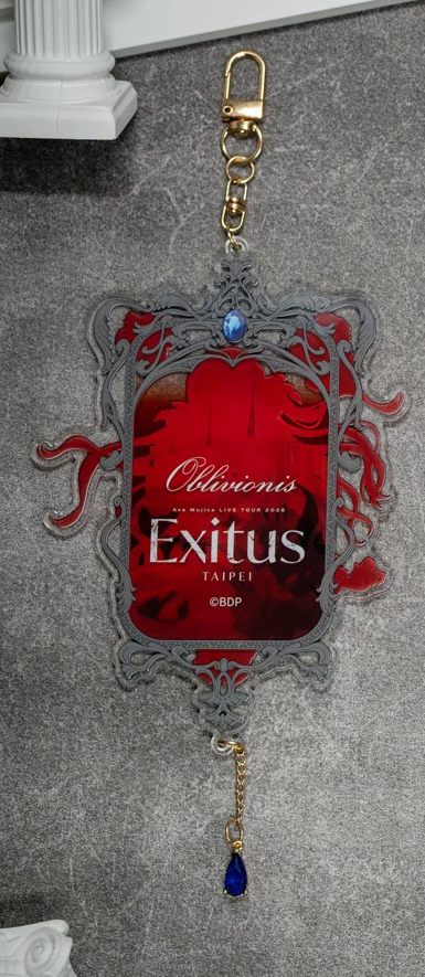 Back of the Oblivionis keychain: red silhouette with the Ave Mujica LIVE TOUR 2026 Exitus TAIPEI logo