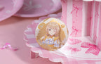 Kotone Fujita design: winking, with braided blonde hair on a gold background