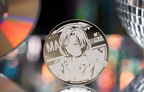 The MASKING badge standing in front of a CD and a mirror ball (props not included)