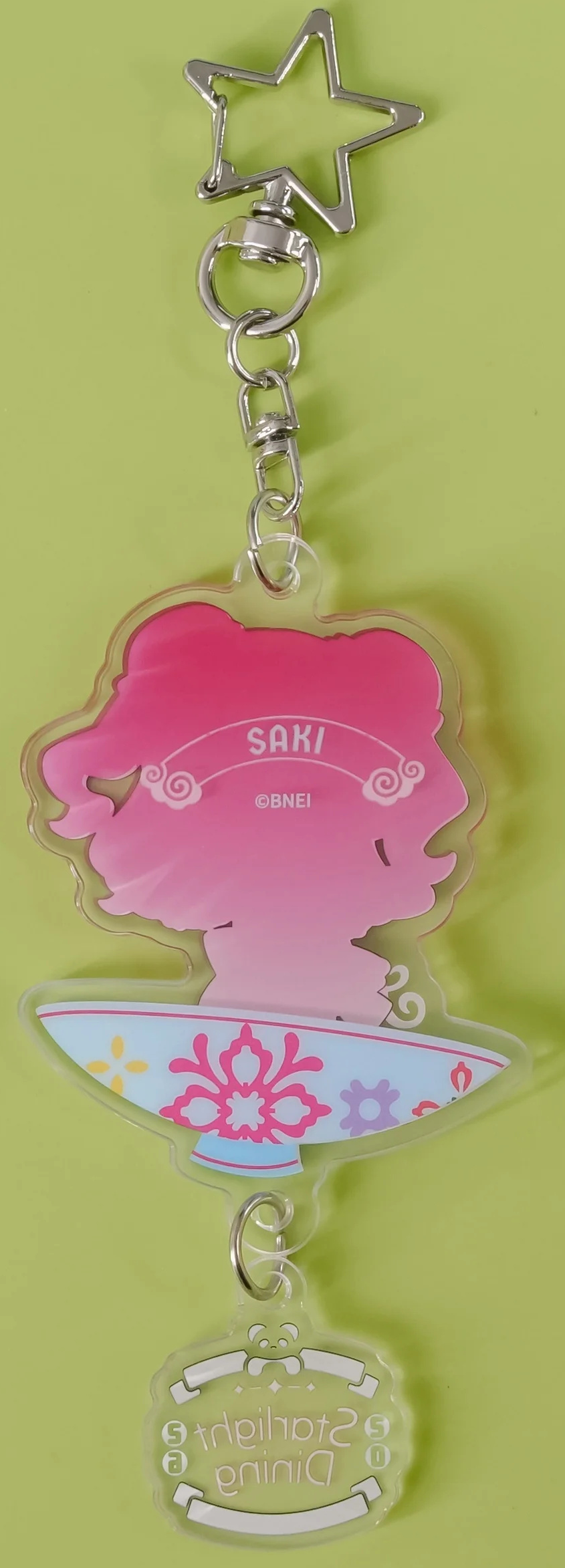 Back of the keychain: silhouette printed with the name SAKI